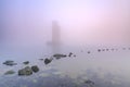 Pillar of a storm surge barrier in fog during sunset Royalty Free Stock Photo