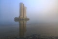 Pillar of a storm surge barrier in fog during sunset Royalty Free Stock Photo