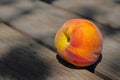 One ripe peach on wooden table Royalty Free Stock Photo