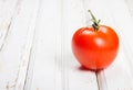 One ripe tomato on white wooden background Royalty Free Stock Photo