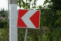 One road sign turning direction with red  white arrows Royalty Free Stock Photo