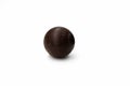 One round brown chocolate candy with a design like Death Star of Star Wars on a white background