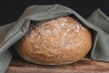 One wheat round bread with fiber on a black background. Royalty Free Stock Photo