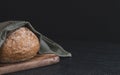 One wheat round bread with fiber on a black background. Royalty Free Stock Photo