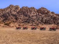 One row of ATVs in the Sinai desert against the backdrop of mountains, no people Royalty Free Stock Photo