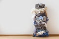 One row of stacked metal laundry basket with full of clothing on white background.