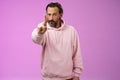 One rule listen. Serious-looking bossy focused determined adult bearded male in pink hoodie extend index finger first