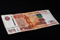 One Russian bill in the amount of 5000 rubles lies on a black background Royalty Free Stock Photo