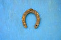 One rusty ancient horseshoe on wooden wall