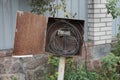 One rusty open iron box with electrical black wires