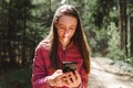 One 13s girl making a video call to her friend in the forest, Online communication concept.Nice sunny spring day