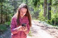 One 13s girl making a video call to her friend in the forest, Online communication concept.Nice sunny spring day