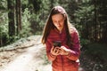 One 13s girl making a video call to her friend in the forest, Online communication concept.Nice sunny spring day