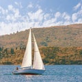 One sailboat with white sail on the water. Montenegro, Bay of Kotor. Travel concept Royalty Free Stock Photo