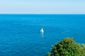 One Sailing yacht in the middle of brigh blue sea. Travel and active lifestyle concept. Selective focus. copy space.