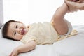 A small cute little baby girl was lying down, her diaper was being changed by her father Royalty Free Stock Photo