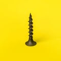 One screw on a yellow background.