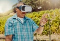 One senior mixed race farmer using a virtual reality headset through metaverse. Hispanic elderly man touching augmented