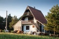Residential house, a mountain chalet building, called vikendica, with a flock of goats in the Balkans in Divcibare, Serbia