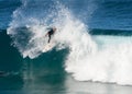 A male surfer executing a slashing backside top-turn off-the-lip at Iluka`s North Wall.