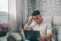 One serious and focused young entrepreneur working hard and analyzing market at home. Teenager boy studying and doing homework for Royalty Free Stock Photo