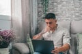 One serious and focused young entrepreneur working hard and analyzing market at home. Teenager boy studying and doing homework for Royalty Free Stock Photo