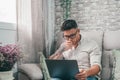 One serious and focused young entrepreneur working hard and analyzing market at home. Teenager boy studying and doing homework for Royalty Free Stock Photo