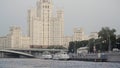 One of Seven Sisters, beautiful skyscraper in the Stalinist style, Moscow river and touristic ships. Action. Concept of Royalty Free Stock Photo