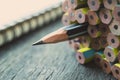 One sharpened pencil standing out from the other new pencil on w Royalty Free Stock Photo