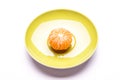 One shelled mandarin on saucer