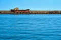 Old rusty boat on a concrete pier Royalty Free Stock Photo