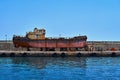 Old rusty boat on a concrete pier Royalty Free Stock Photo