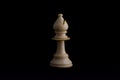 one side light on white bishop chess piece in black background