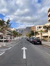 One side road with the road sign on it. Street with parallel parked cars. Royalty Free Stock Photo