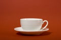 One simple coffee cup on brown color background, closeup photo