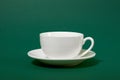 One simple coffee cup on green color background, closeup photo