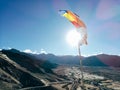 One single Buddhist prayer flag in six colors fluttering in mountain region against the sunlight Royalty Free Stock Photo