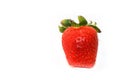 Fresh and natural red strawberry of rectangular shape, with green leaves, isolated on a seamless white background.