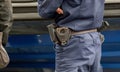 One single generic anonymous policeman, police officer wearing a blue uniform, equipment closeup, handcuffs, pepper spray, detail