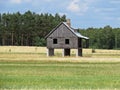 One Single House Standing on Pillars in the Middle of Field Royalty Free Stock Photo