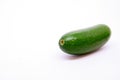 One single mini avocado on white background.