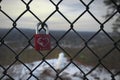 Isolated red padlock on fence