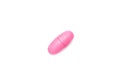 One single pink pill on white background, multivitamin tablet or dietary supplement