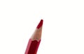 One single sharp red color wood pencil placed in front of white background