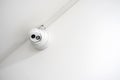 One single simple security camera on a white wall, modern real estate flat security system, safety industrial public area