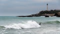 Surfer surfing a wave in Biarritz, France