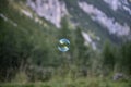 One single transparent soap bubble floating through the air