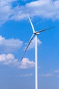 One single windmill turbine with partly cloudy blue sky in background. Renewable energy wind turbine Royalty Free Stock Photo