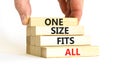 One size fits all symbol. Concept words One size fits all on wooden blocks. Businessman hand. Beautiful white table white