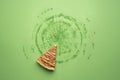 One slice of apple pie on green background